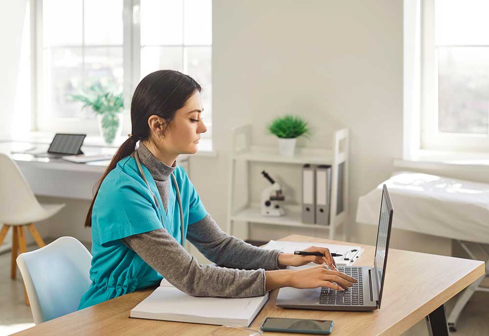 Doctor using laptop online