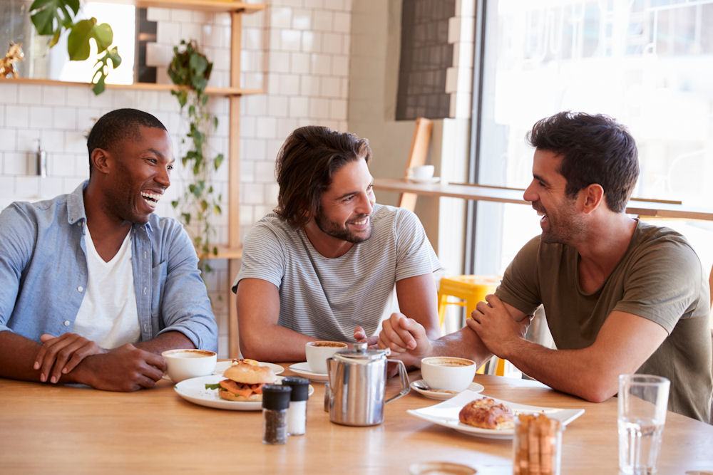Three men enjoying breakfast at meth addiction center