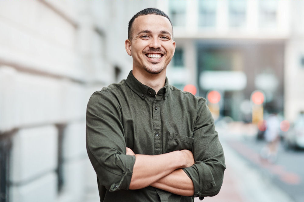 Smiling man standing with arms crossed