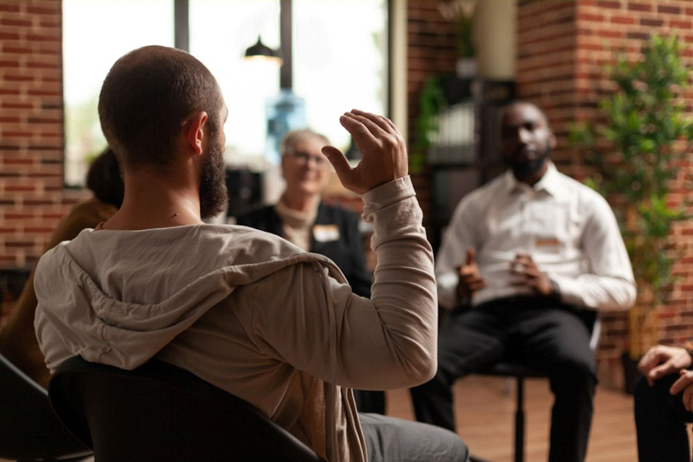 Man gesturing while seated in addiction treatment in Lancaster, PA Man gesturing while seated in addiction treatment in Lancaster, PA